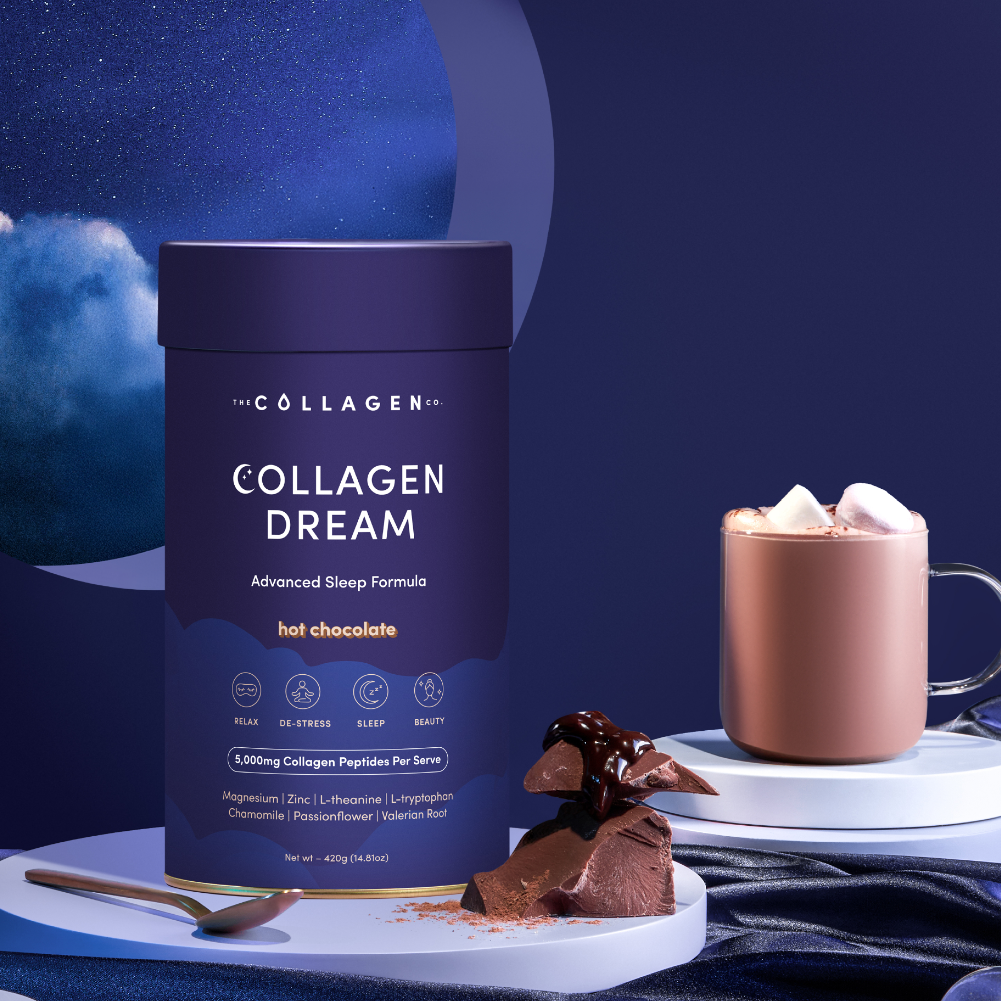 Collagen Dream Hot Chocolate tub styled with a glass of hot chocolate topped with marshmallows, and a chocolate truffle on a soft blue background with moon and cloud elements.